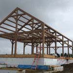View of full timber frame home completed being raised.